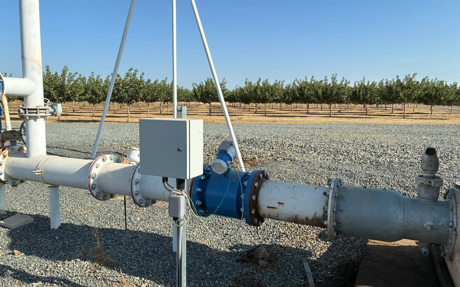 A Gold Series meter and remote telemetry installed on a mainline at the edge of a pistachio orchard